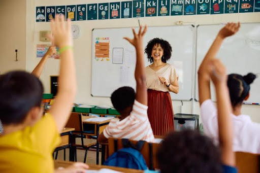 Students raising hands in class