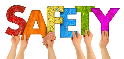 Hands holding colorful letters spelling “SAFETY"