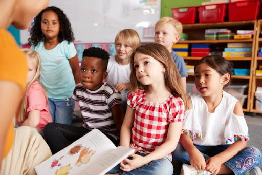 Children attentively listening during interactive classroom learning