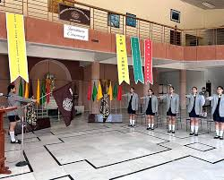 Girls participating in a school ceremony indoors