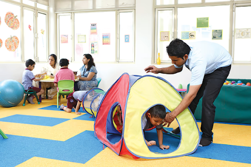 Teacher guiding children during playtime