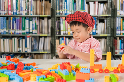 Child building with blocks in a library