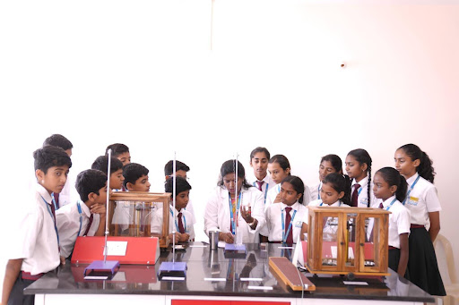 Students and teacher performing an experiment