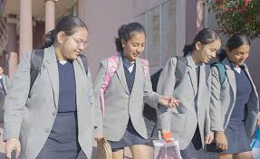 Girls in school uniforms walking together on campus