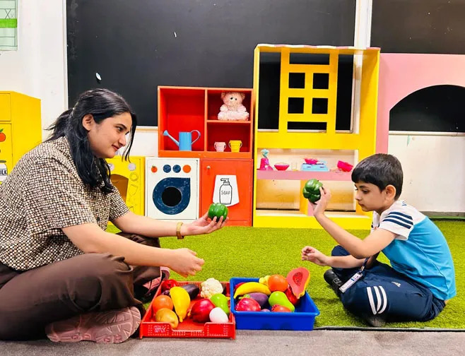 Child and teacher at Manav Rachna International School, Noida