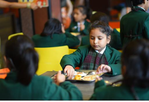 Student eating a healthy meal in school cafeteria