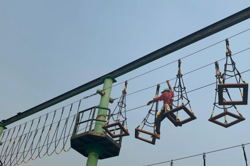 Student building strength and balance on a rope course